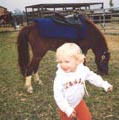 Anna with a pony at a pumpkin patch in Howard County, October 2003. Photo by Chris Harvey