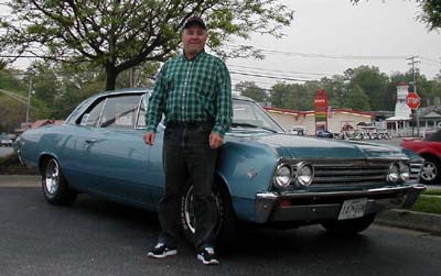 John Broussard posing by his 1967 Chevelle