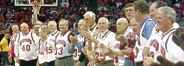 The 1957-58 team is honored at half-time.