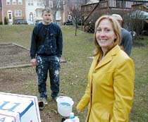 Pete Stelnyk and Chellis Gonzalez  paint a sign for presidential candidate Ron Paul behind a Silver Spring townhouse.