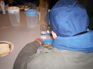 A homeless man eating at a shelter/Newsline photo by Raechal Leone