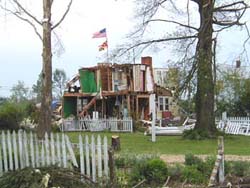 The American and Maryland flags are placed on top of a damaged house in downtown La Plata.