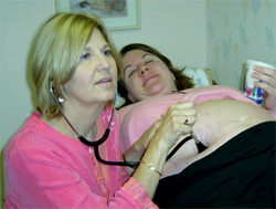 Midwife Eileen Ehudin-Pagano with patient Nadia Young (Photo courtesy of Ken Lopez)