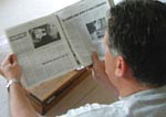 Steve Peck reading a newspaper article about his experience