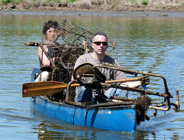 Volunteers haul trophy trash back to the dock from the Anacostia River / Newsline photo by Steven Mendoza